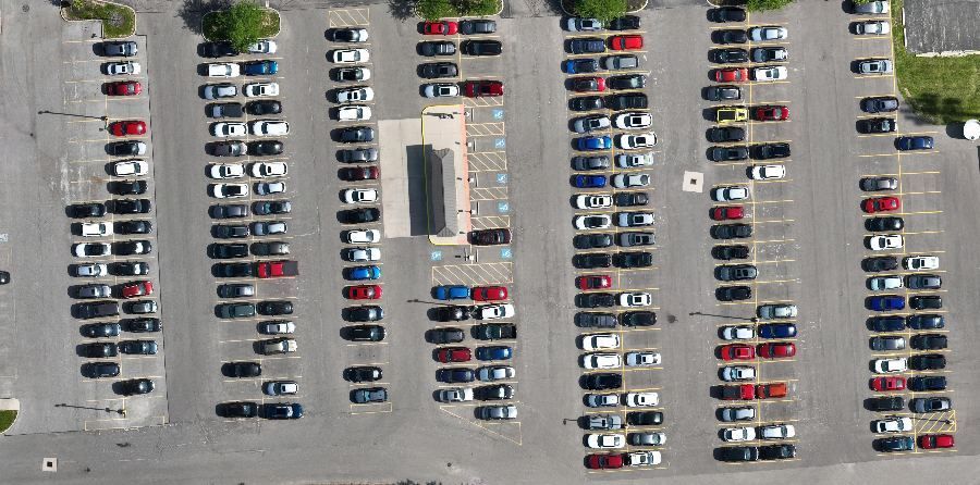 Same shuttle lot at 10 a.m., rows nearly full