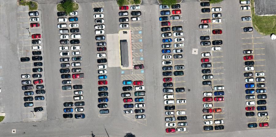 Same shuttle lot at 1 p.m., rows nearly full