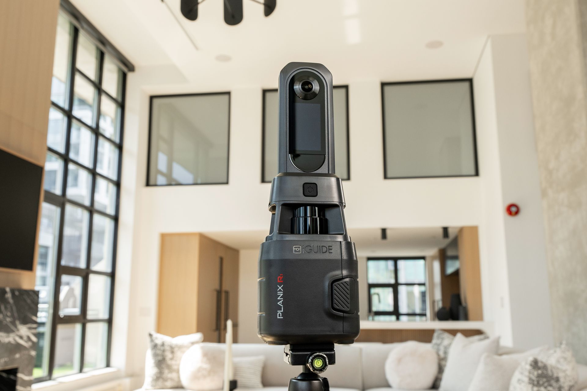 360 camera mounted in a bright modern living room with large windows