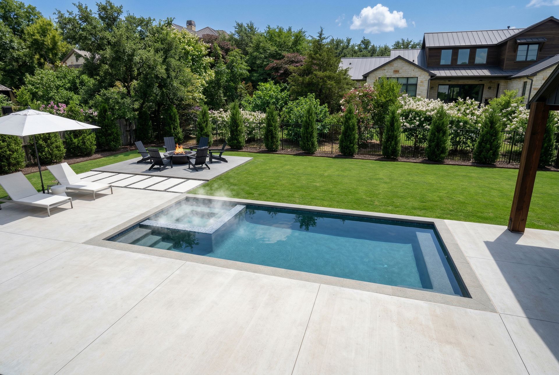 two homeowners sitting and relaxing next to their custom pool in Austin, TX.