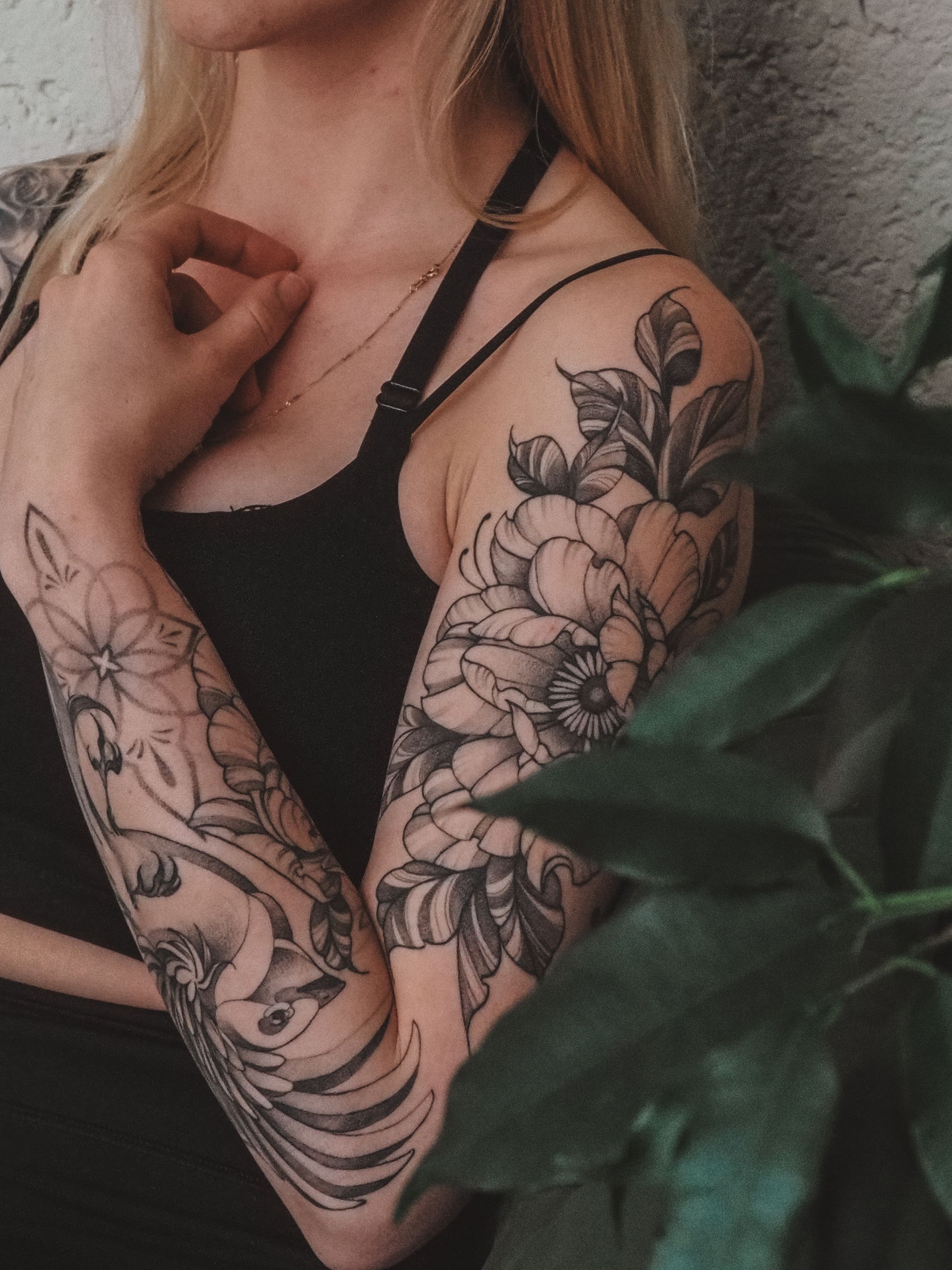 Two people have matching palm trees tattoos on their forearms