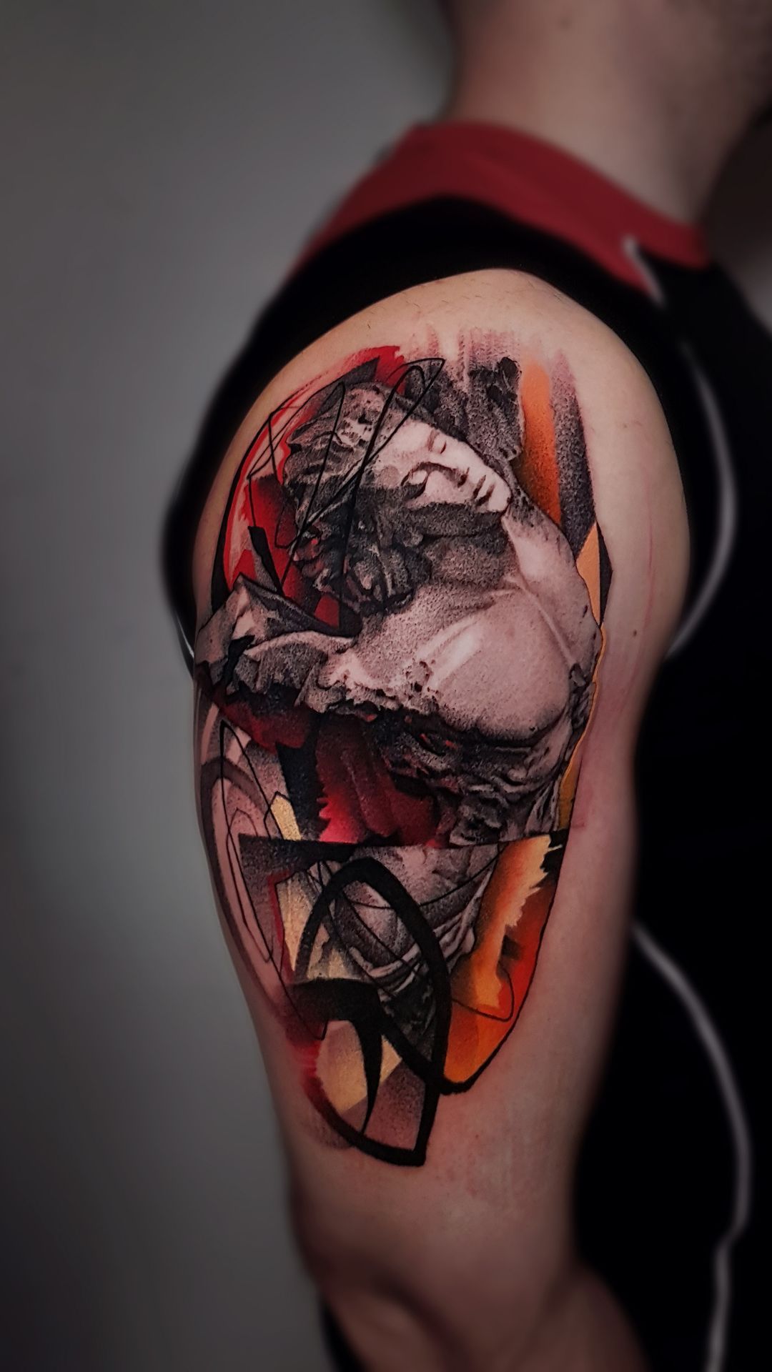 A man has a colorful tattoo on his arm.