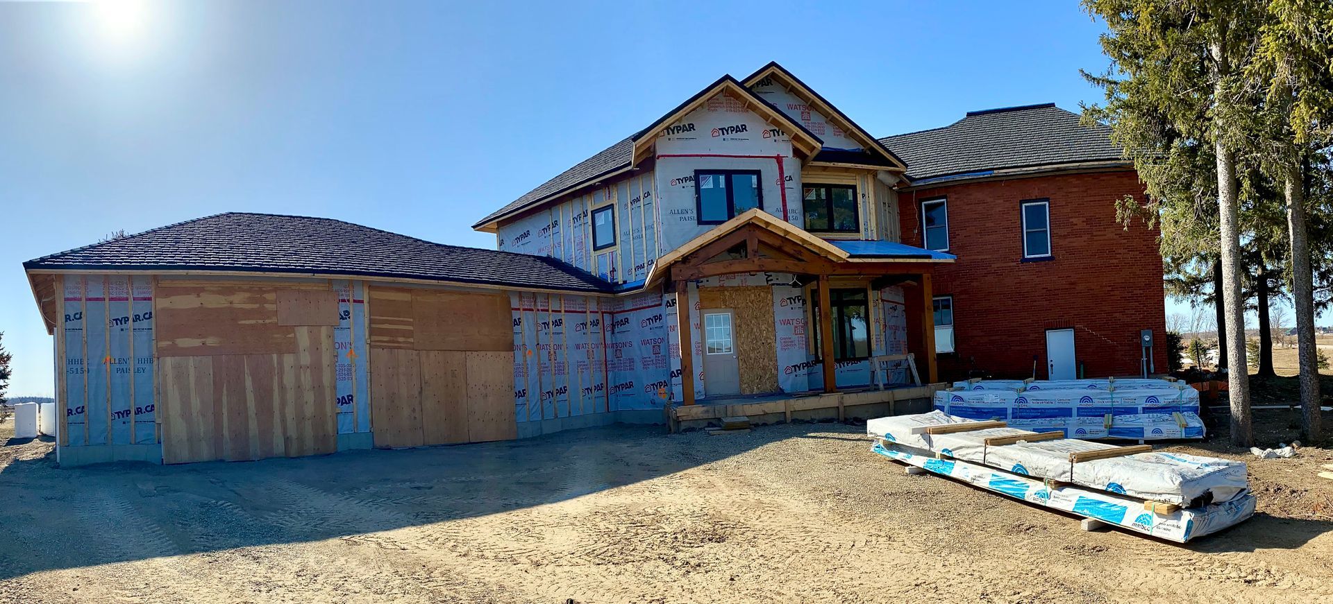 House and garage addition attached to original red brick farmhouse.