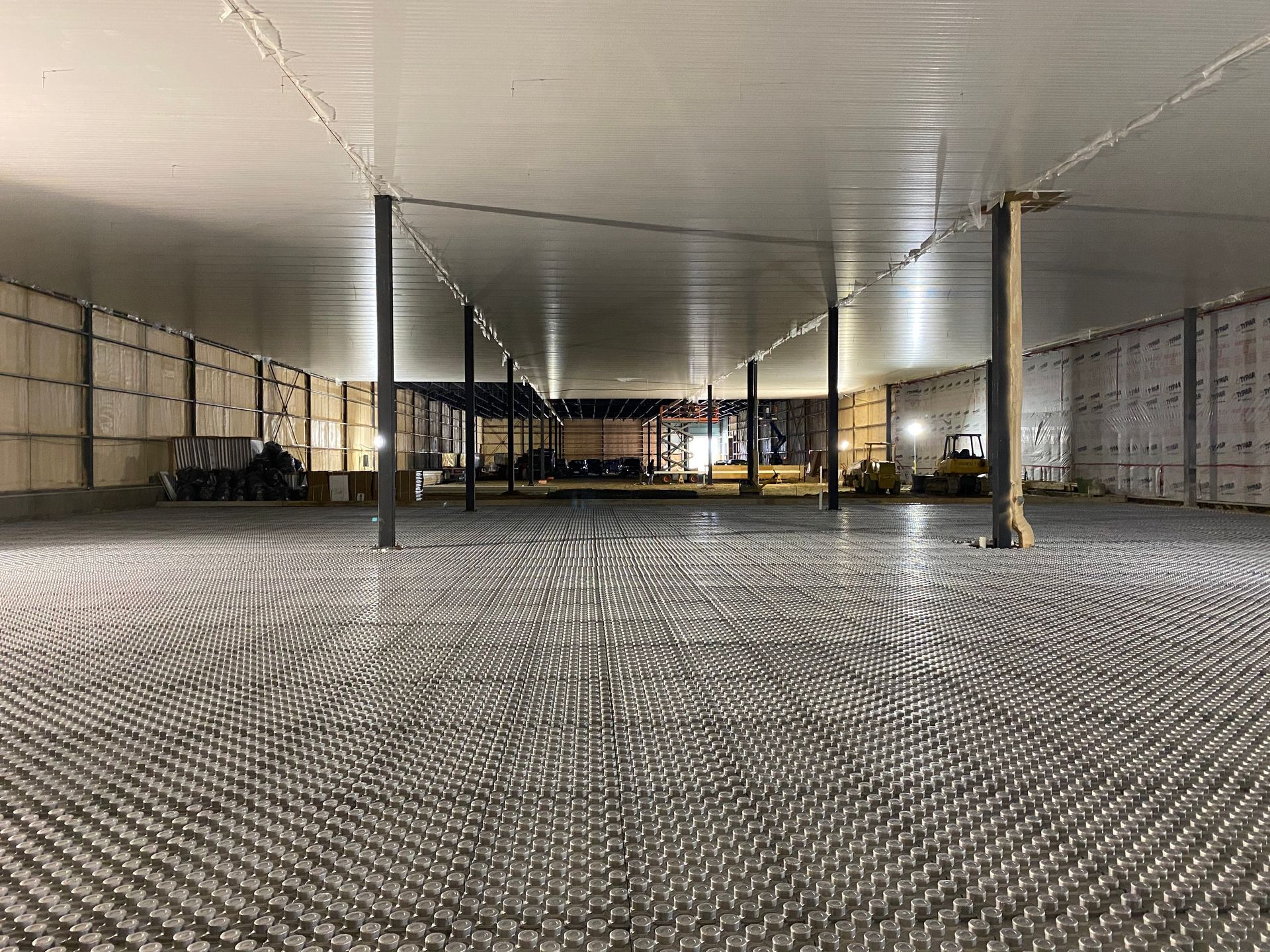 Open agricultural building interior with support columns