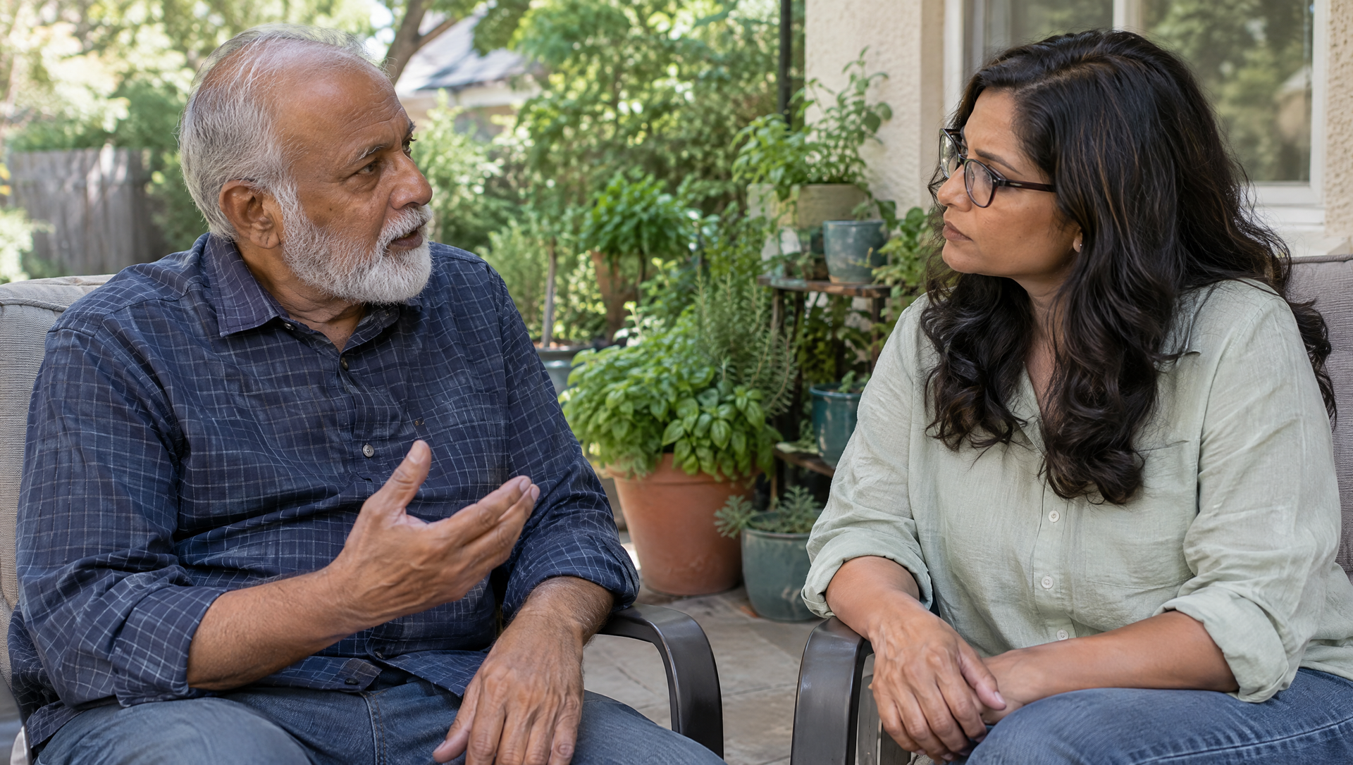 Two people talking on a bench in a garden, with potted plants behind them.
