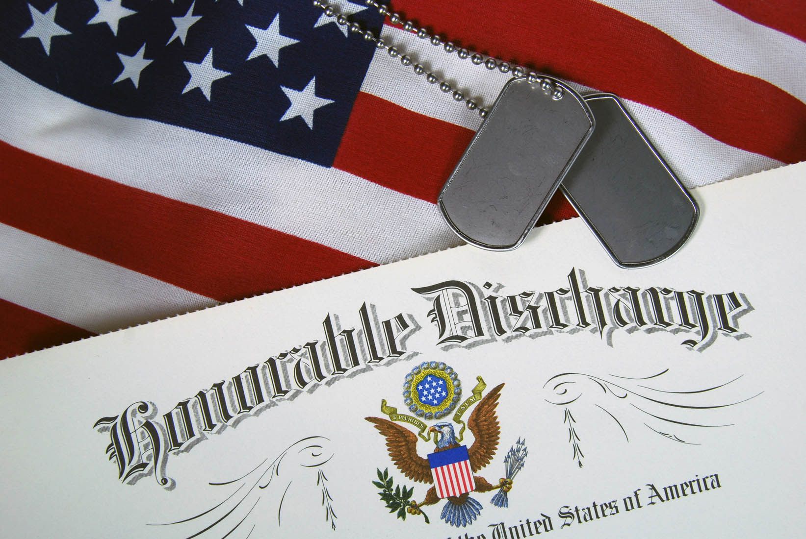 American flag background with dog tags and a General Discharge certificate document