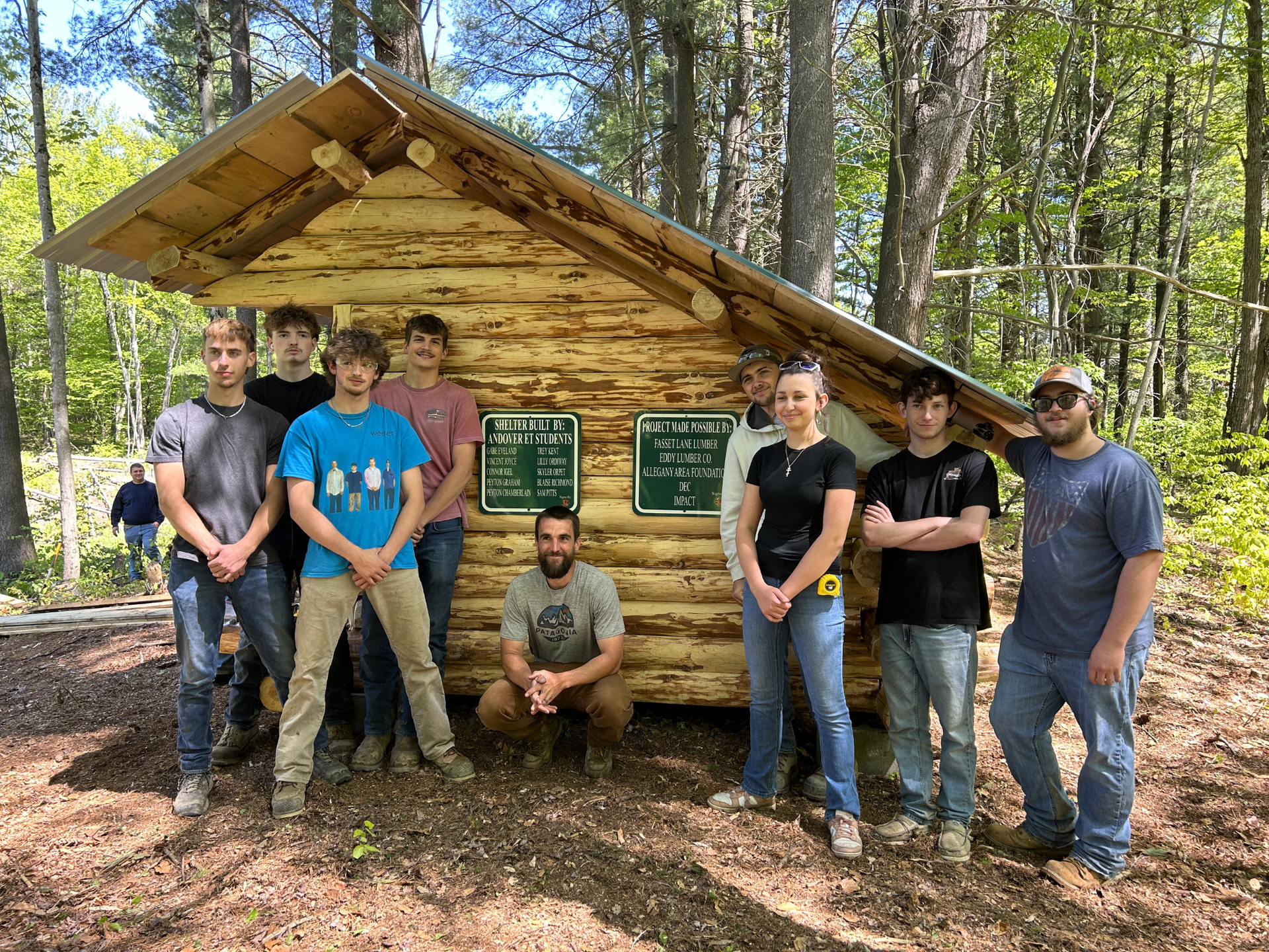 Andover students and Mr. Zach Owens standing in front of new lean-to on West Almond Trail 4