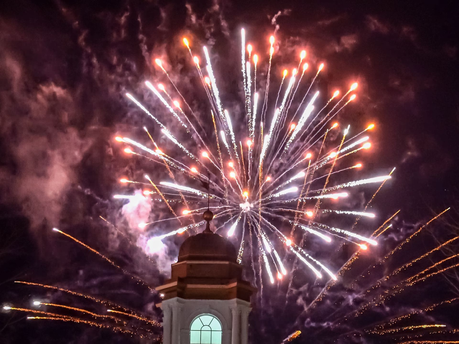 Red and white fireworks in the night sky