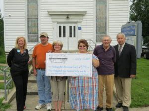 Richburg-Wirt Historical Society holding large check for $4,240