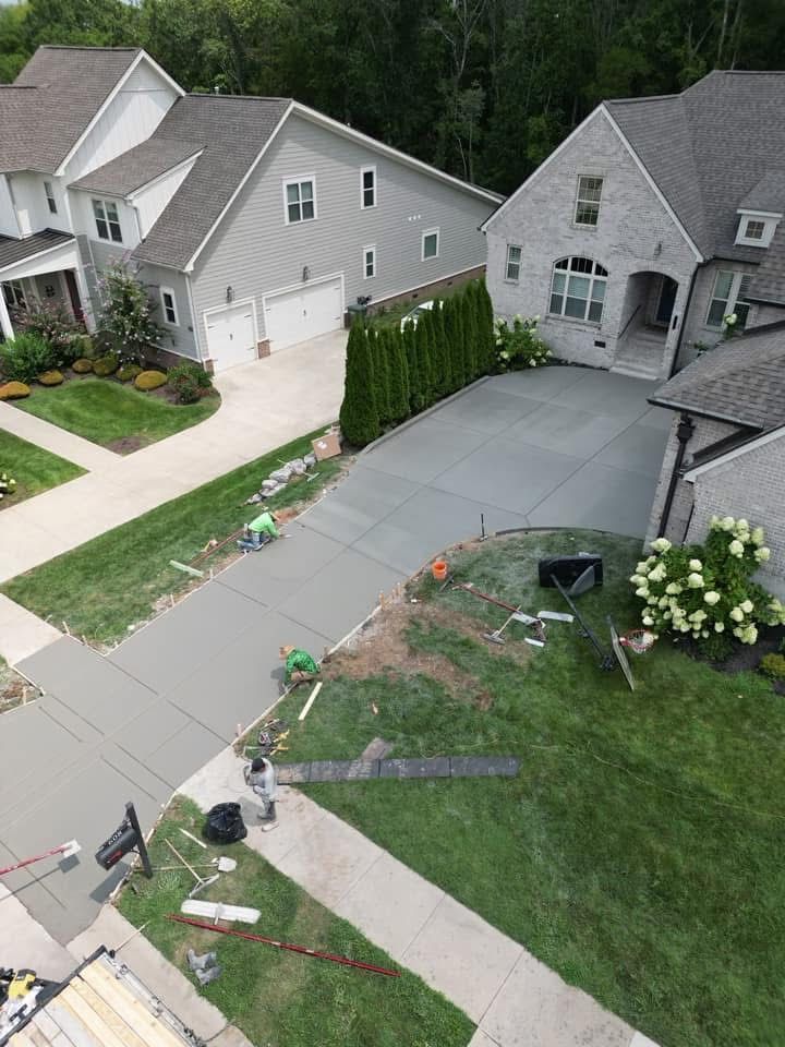 An aerial view of a residential neighborhood with houses and a driveway.