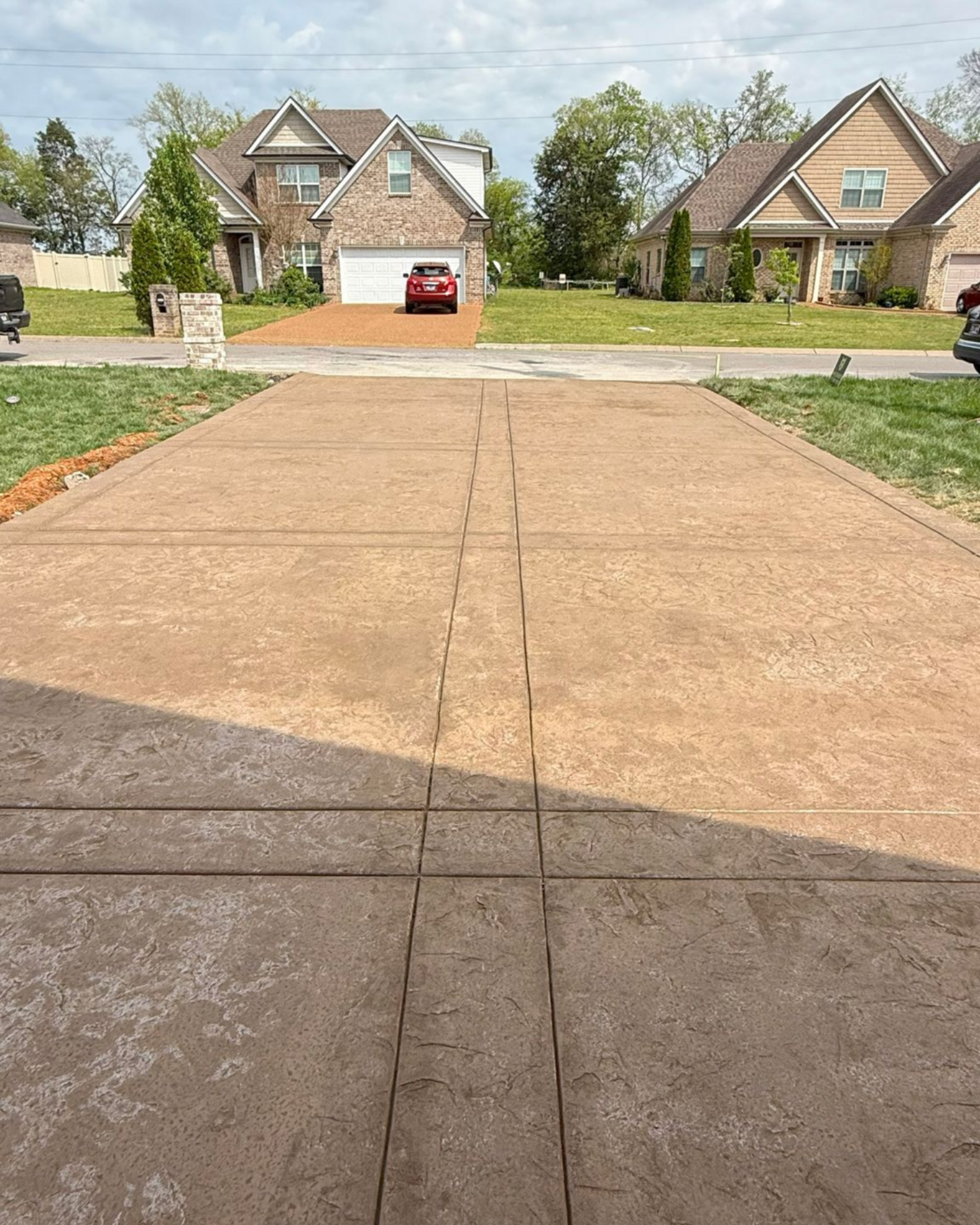 An empty barn with a concrete floor and a wooden roof. Project done by Raise the Bar Construction