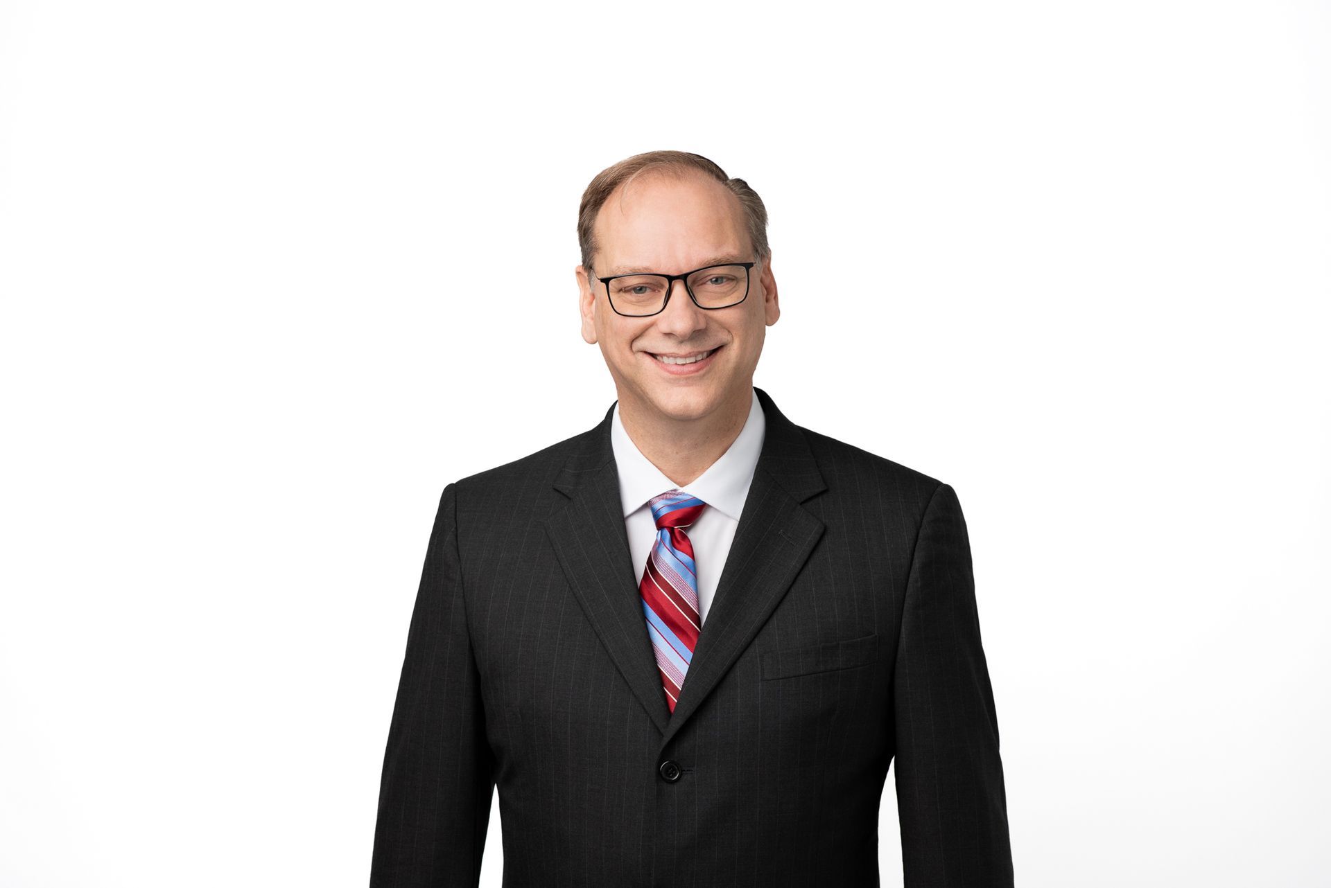 Russell Quinn professional headshot in suit and glasses, featured at Tech Week 2023 Houston cybersecurity event.