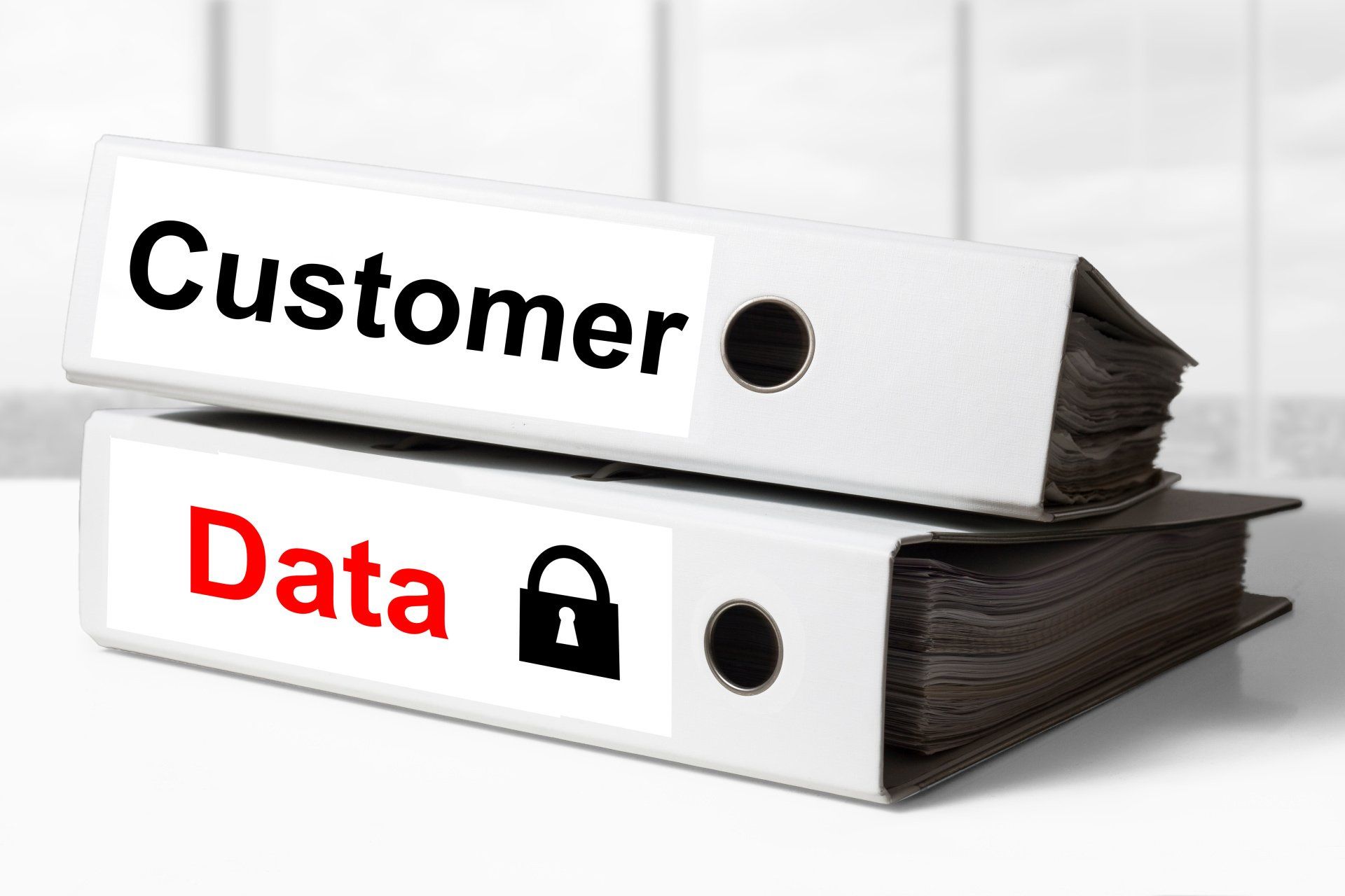Customer data binders labeled with lock icon, representing risk of exposure and need for data privacy.