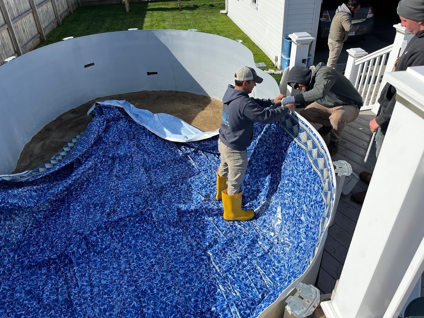 A group of men are working on a swimming pool.