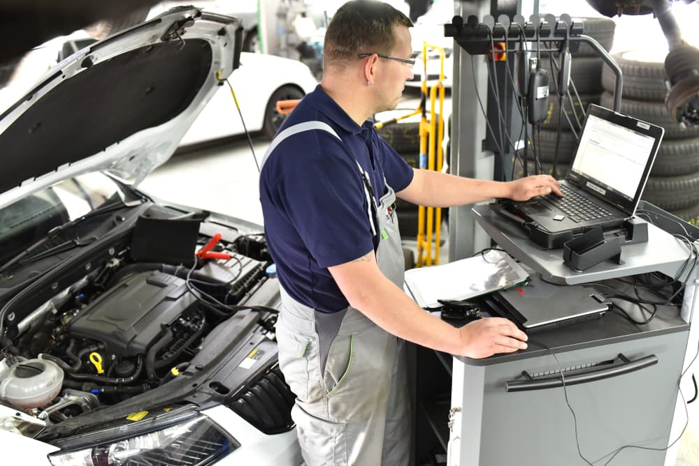 Mechanic Typing On Computer — Car Repairs in Maroochydore, QLD
