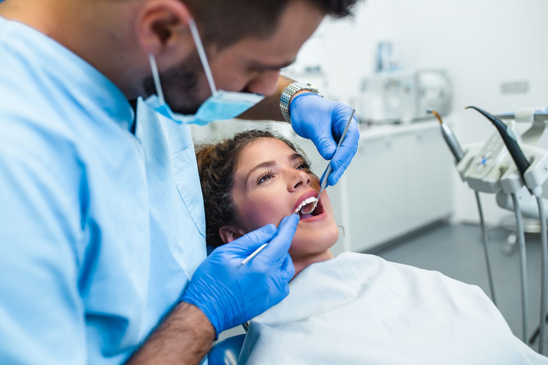 A dentist is working on a patient. A dentist is working on a patient.