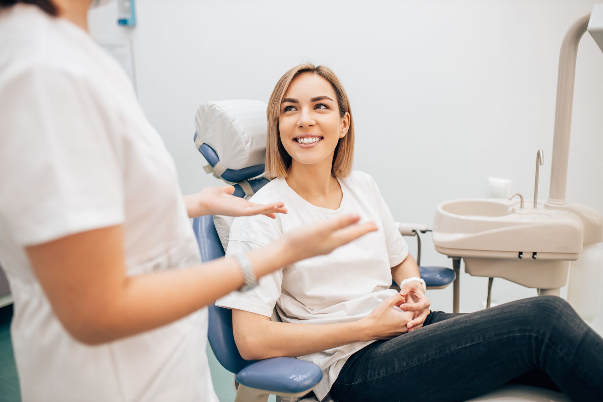 A dentist is talking to a patient.