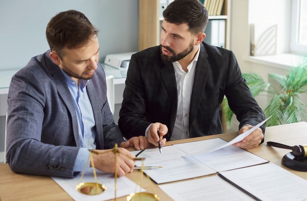 Two Commercial Lawyers Discuss Legal Documents Together