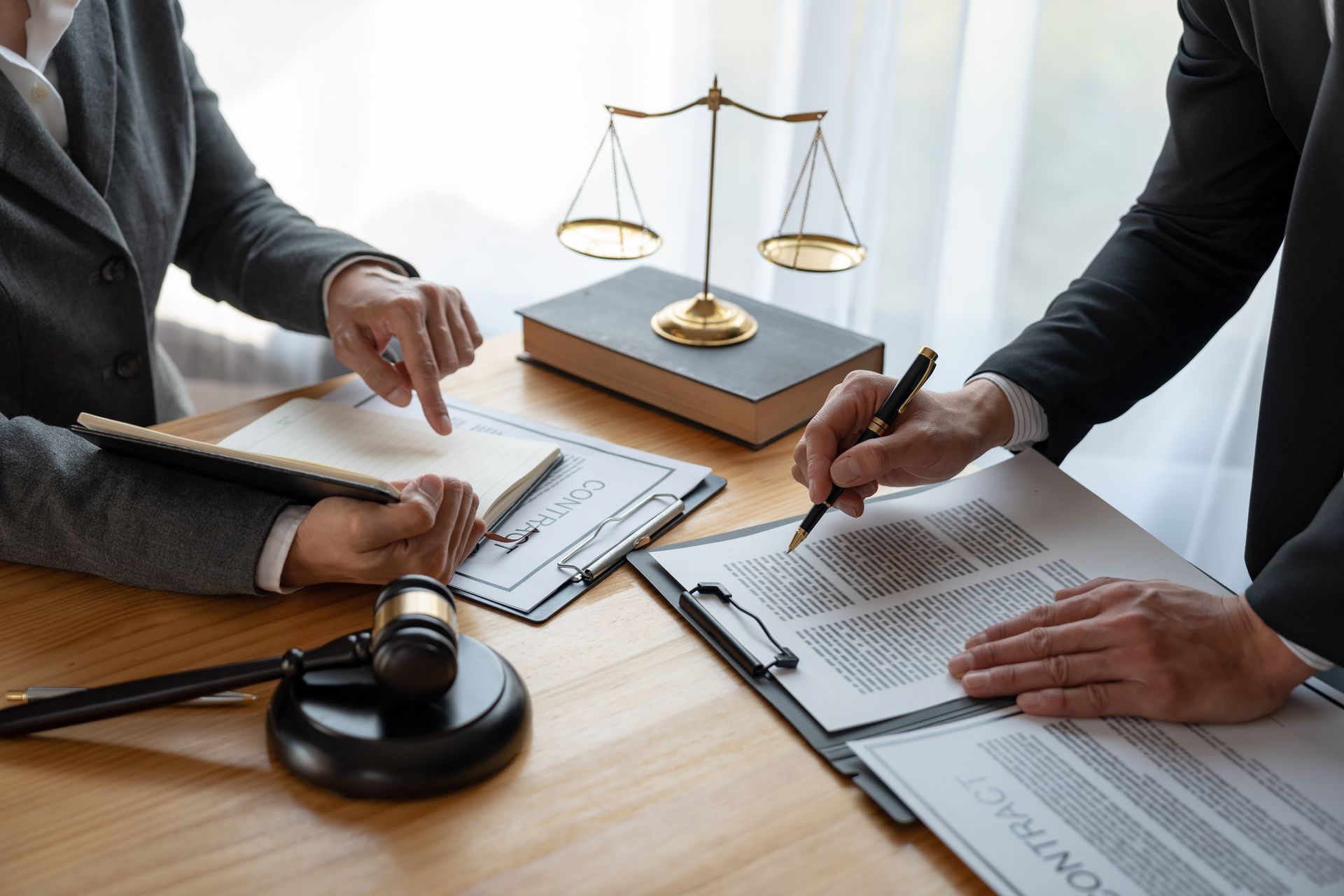 Two Commercial Lawyers Reviewing Property Sale Legal Documents