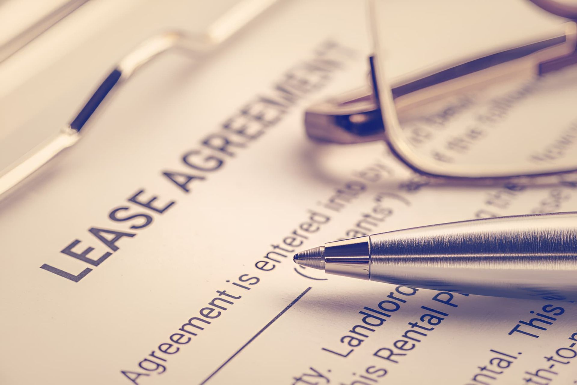 A Pen And Glasses Are On Top Of A Lease Agreement — De Silva Hebron In Darwin City, NT