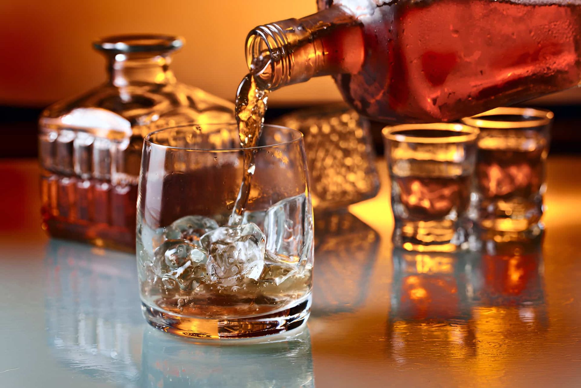 A Person Is Pouring Whiskey Into A Glass With Ice — De Silva Hebron In Darwin City, NT