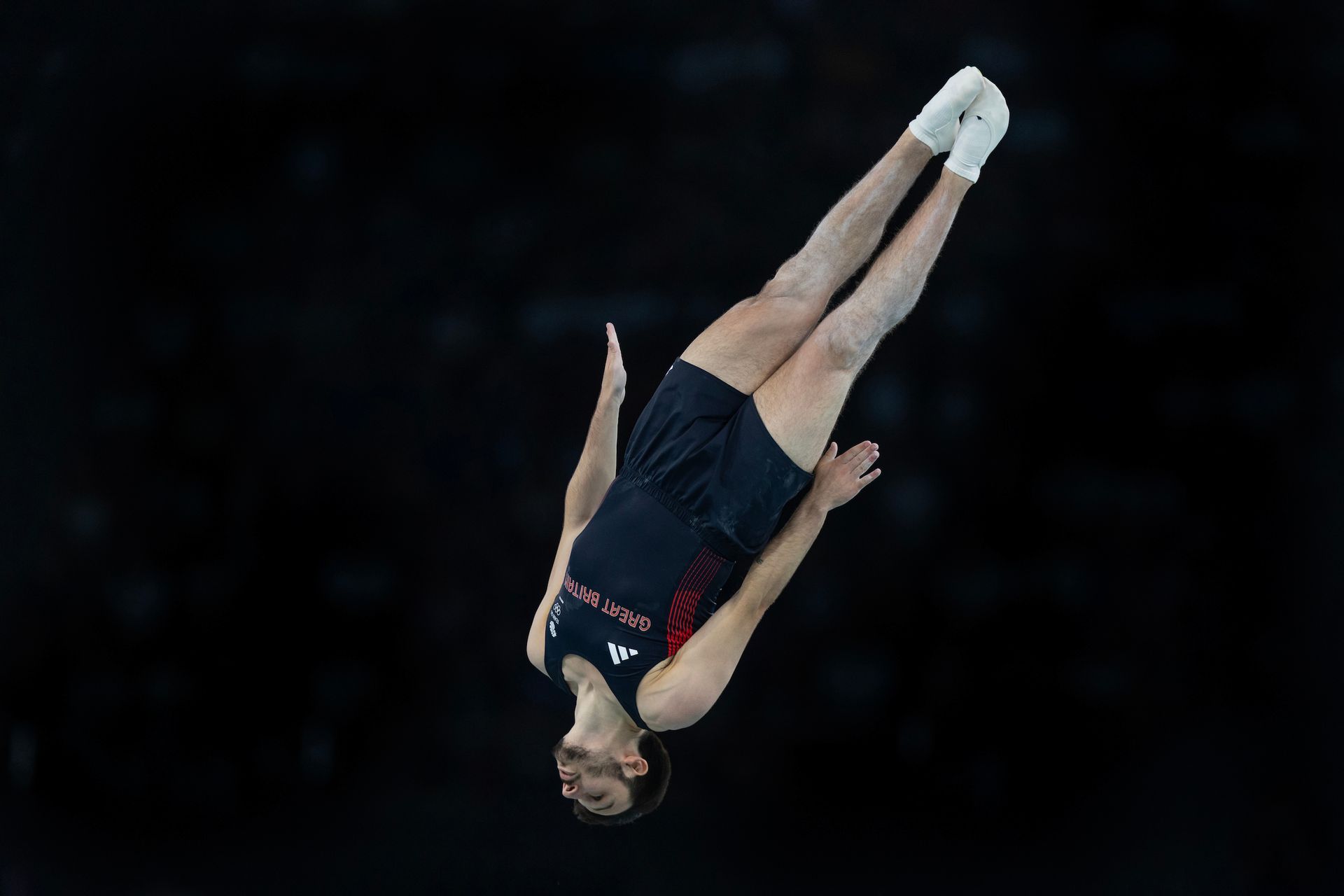 A gymnast is doing a flip on a trampoline.