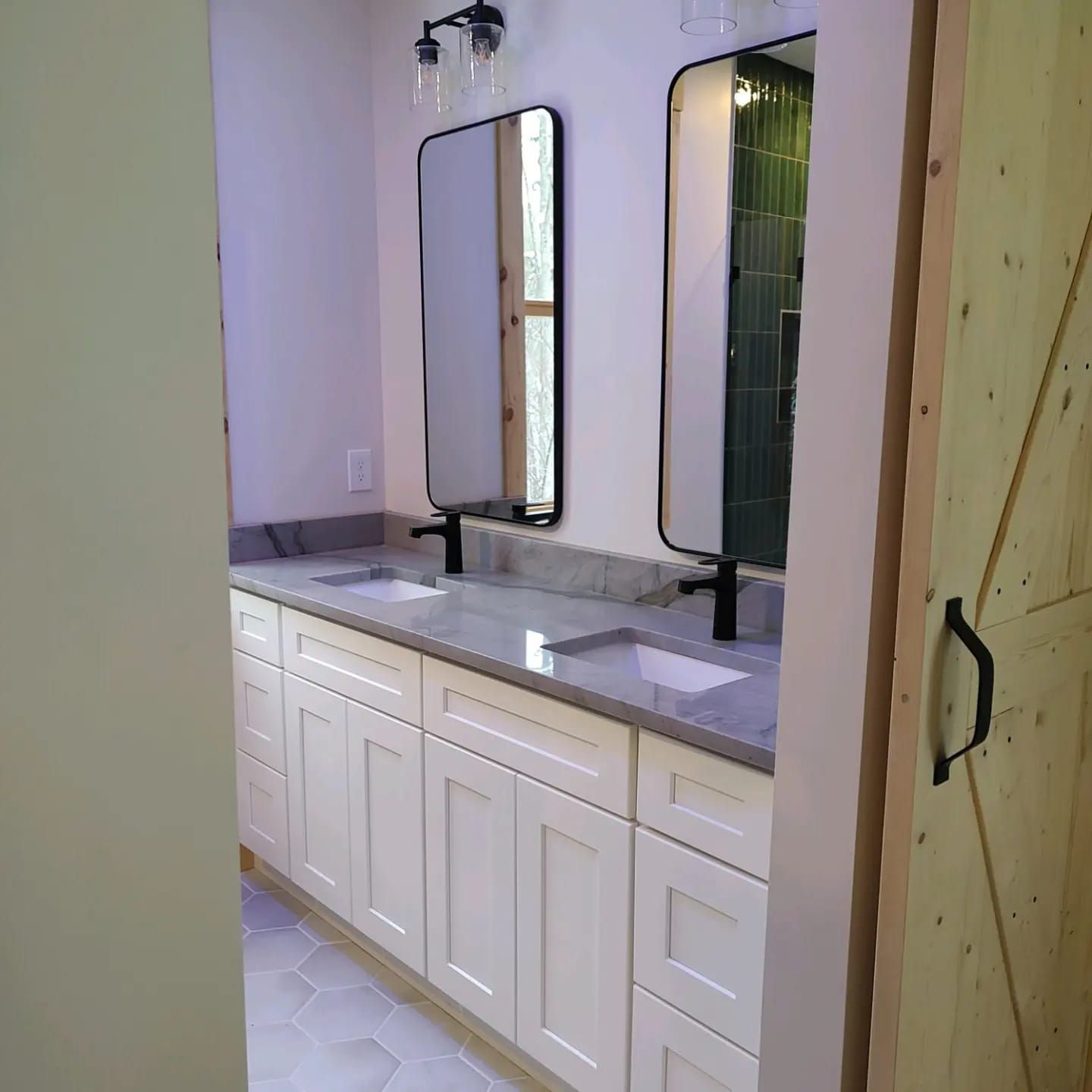 A bathroom with two sinks and two mirrors.