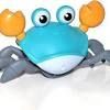 A blue toy crab with orange claws and large, wide-eyed expressions on a white background.