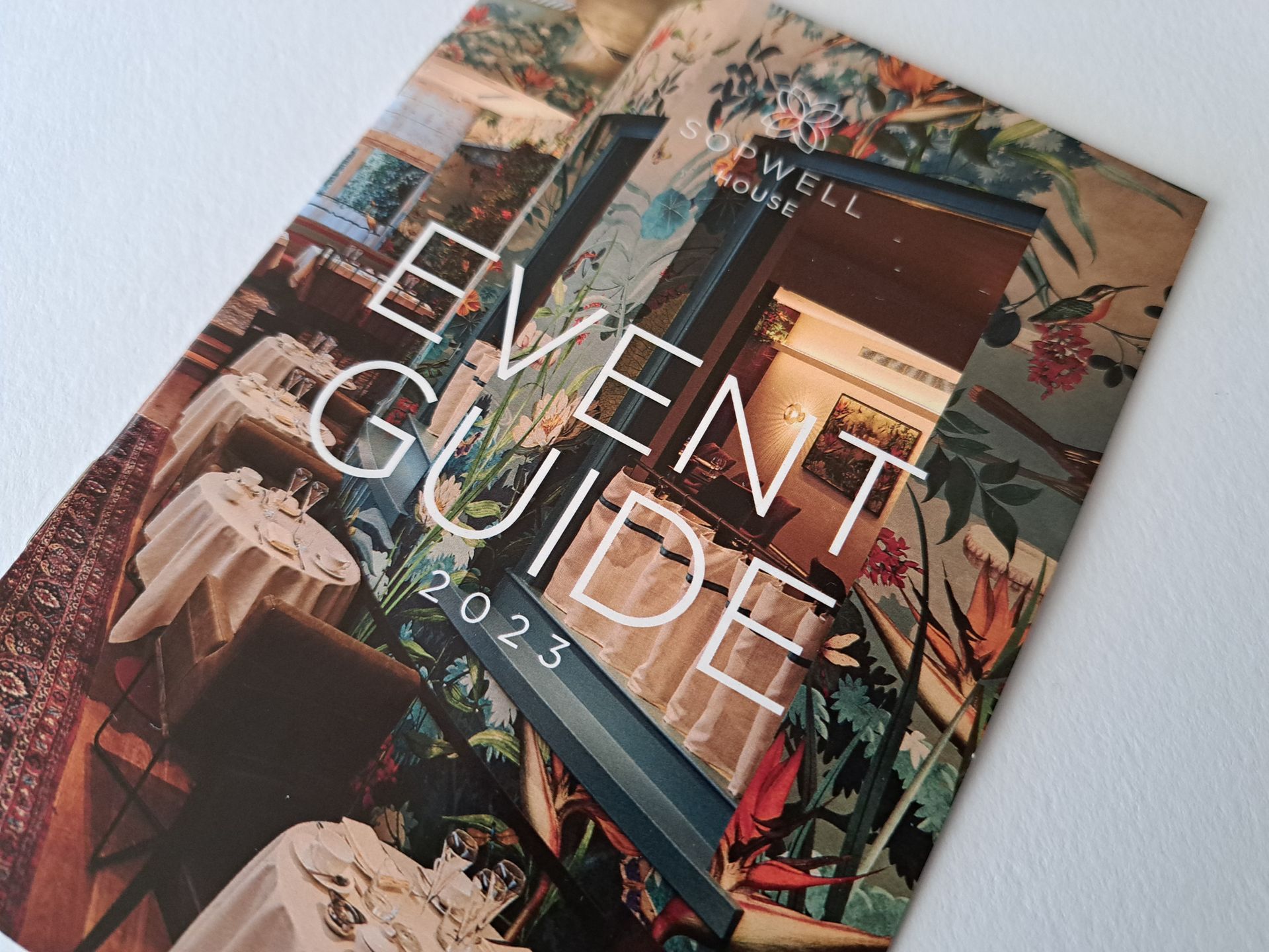 Event guide with floral and interior design background.