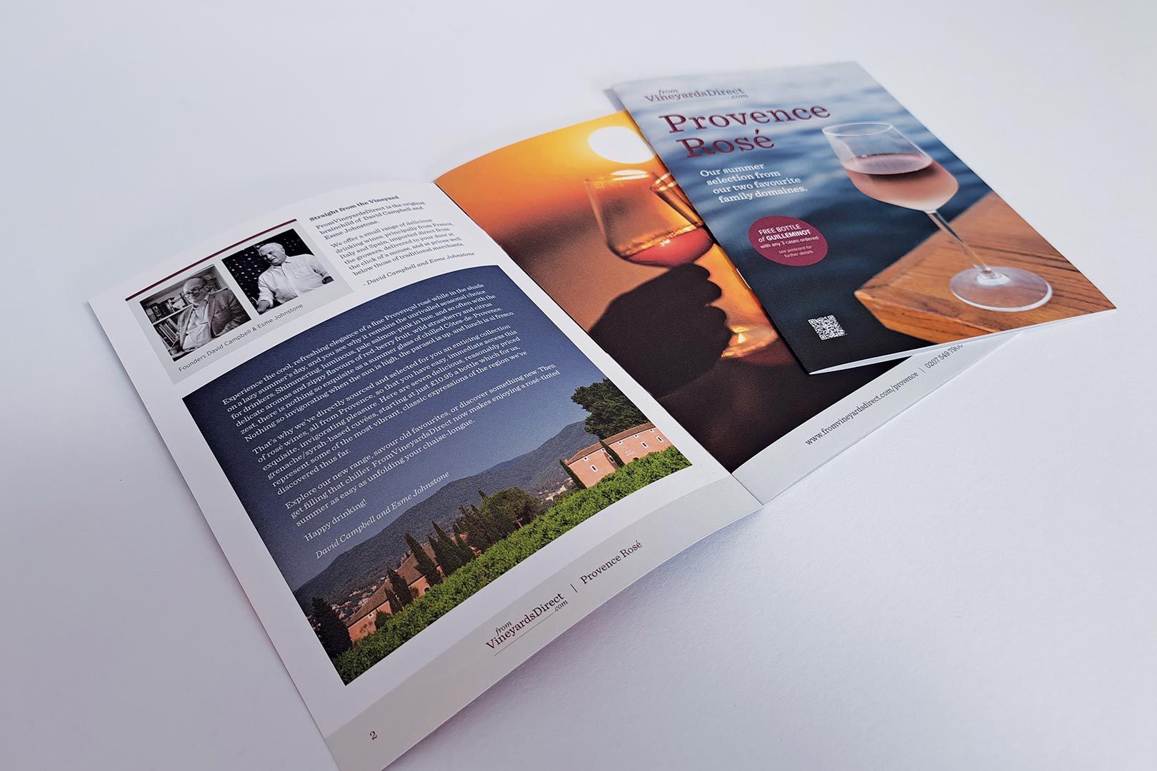 Brochure displaying a sunset, wine, and text; opened to show more content and a photograph.