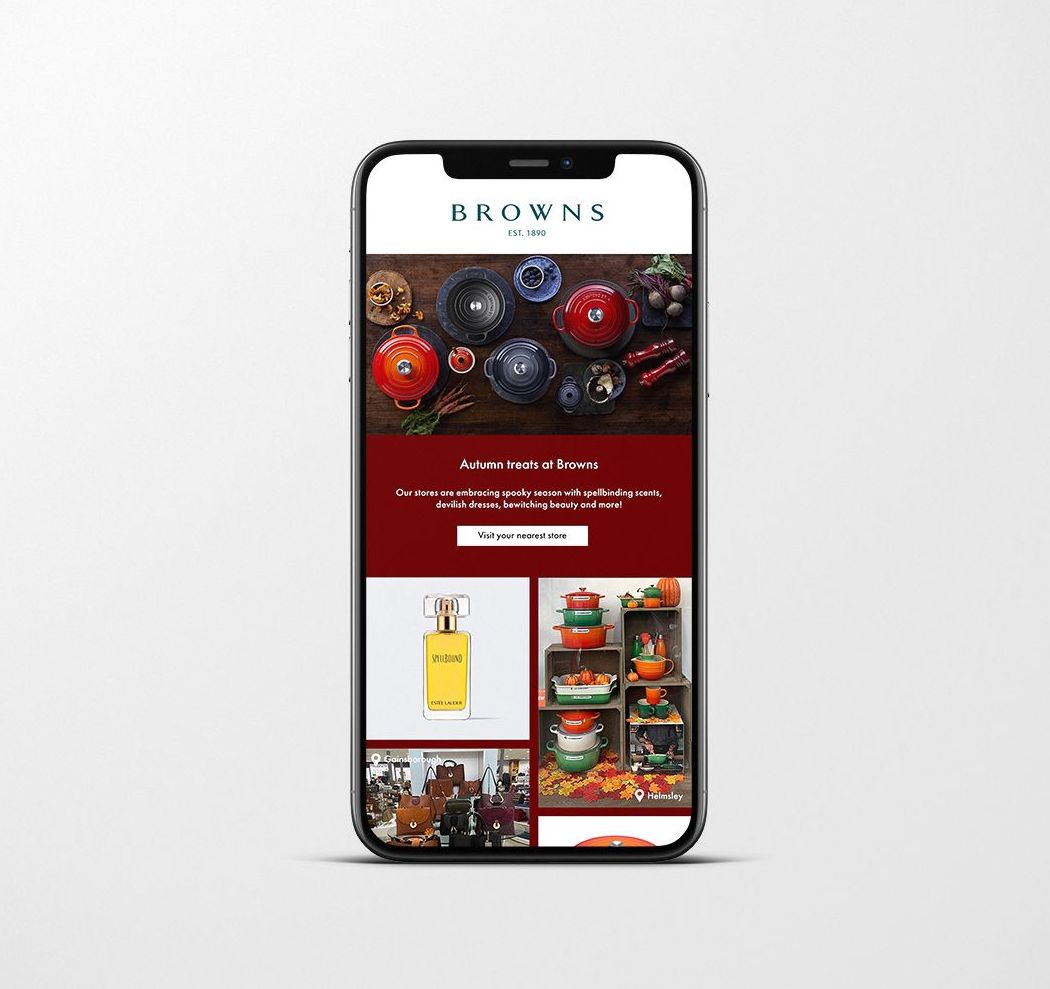 Email from Browns Kitchen on a phone, showcasing cookware in a dark setting, using red and green.