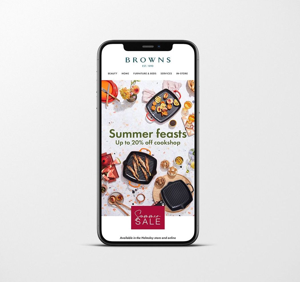 Smartphone displaying Browns Cookshop sale: Summer feasts, up to 25% off cookware.