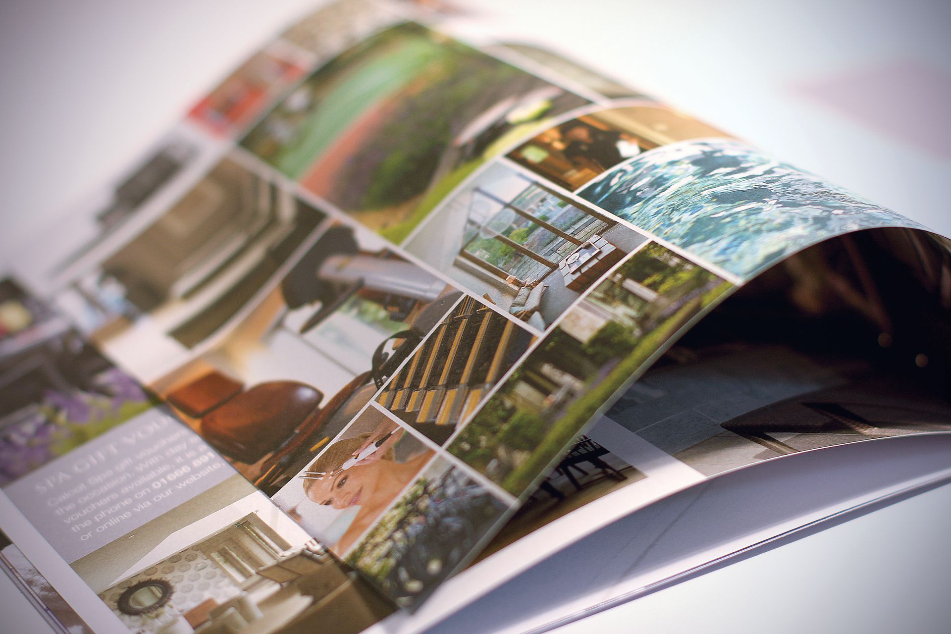 Open magazine with collage of photos, close-up view.