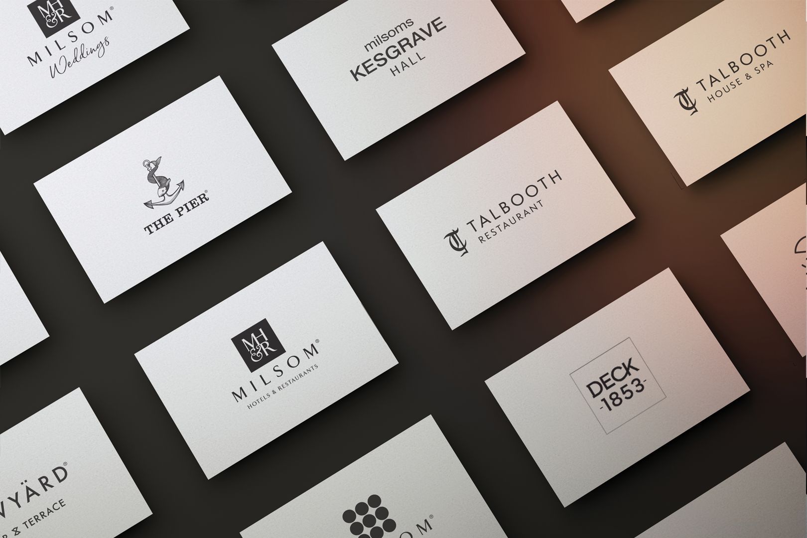 Business cards with logos on a dark background.
