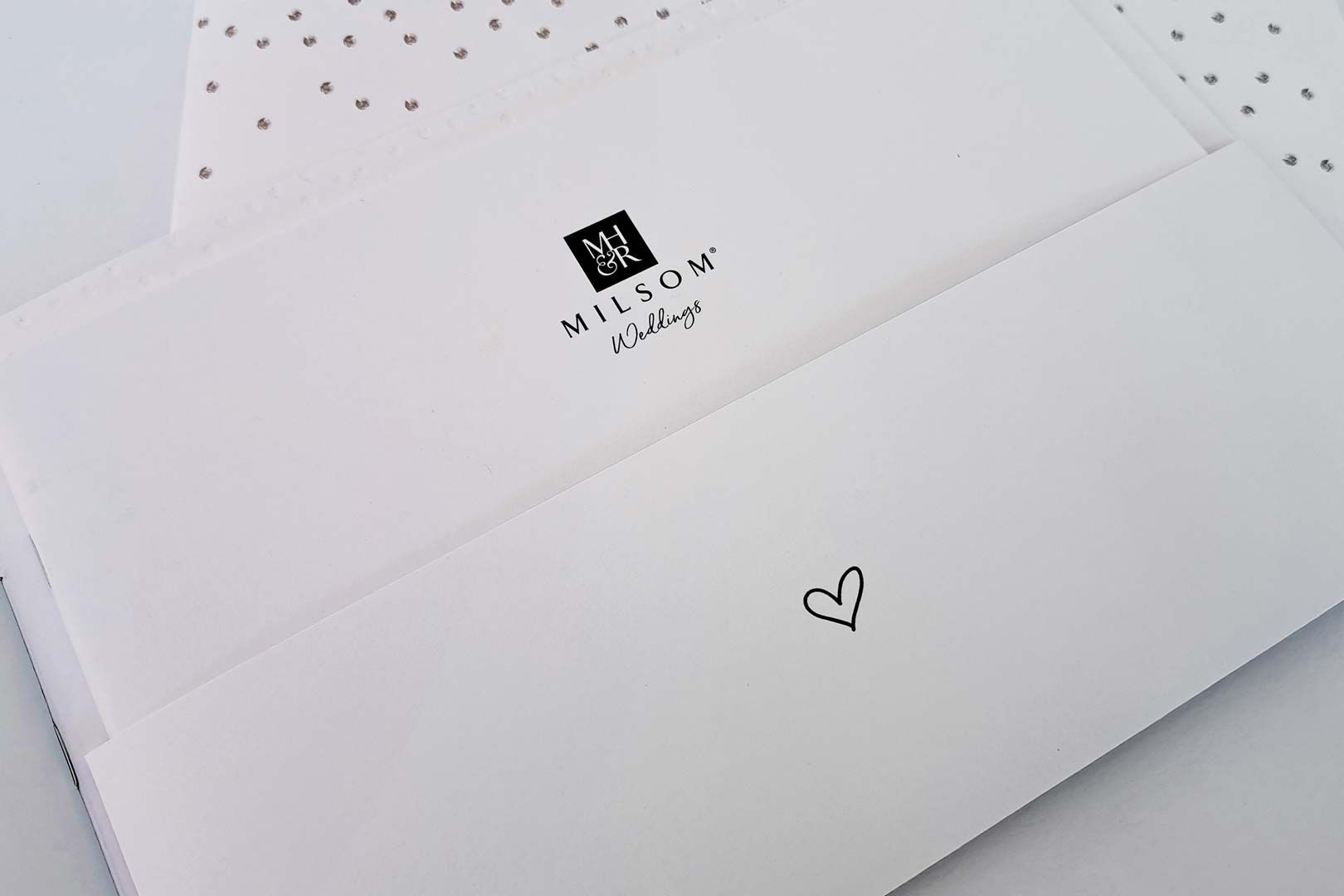 White envelopes with a logo and a small heart.