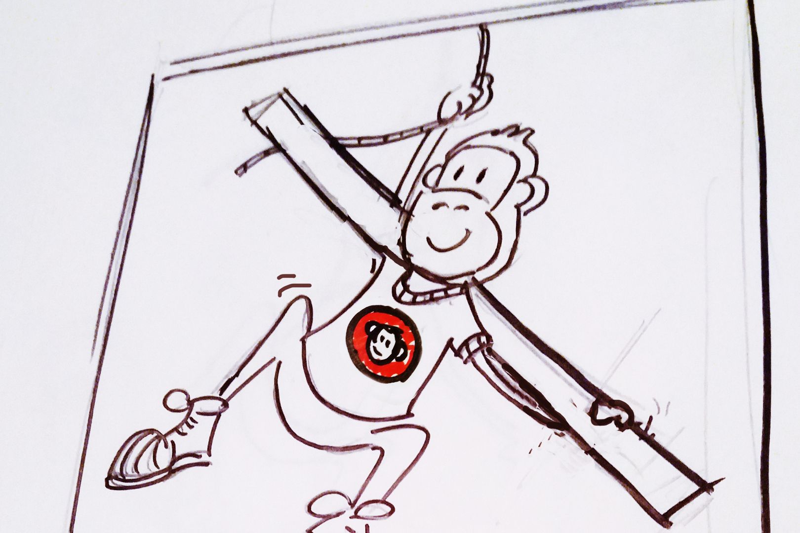 Cartoon monkey hanging from a bar wearing a t-shirt with a monkey face logo.