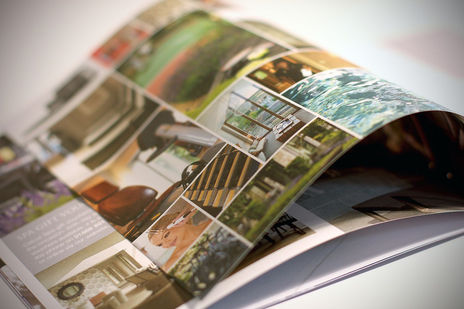 Open magazine showing various photos, possibly garden and home interiors.