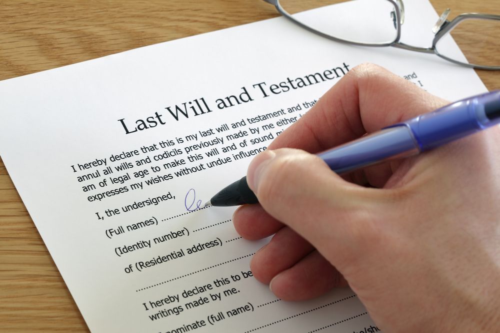 A Person Is Writing A Last Will And Testament — Clarence Valley Legal In Grafton, NSW