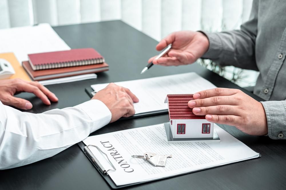 Two Men Are Sitting At A Table — Clarence Valley Legal In Grafton, NSW