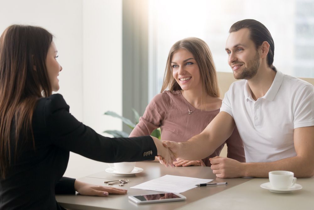 A Woman Is Shaking Hands With A Man — Clarence Valley Legal In Grafton, NSW