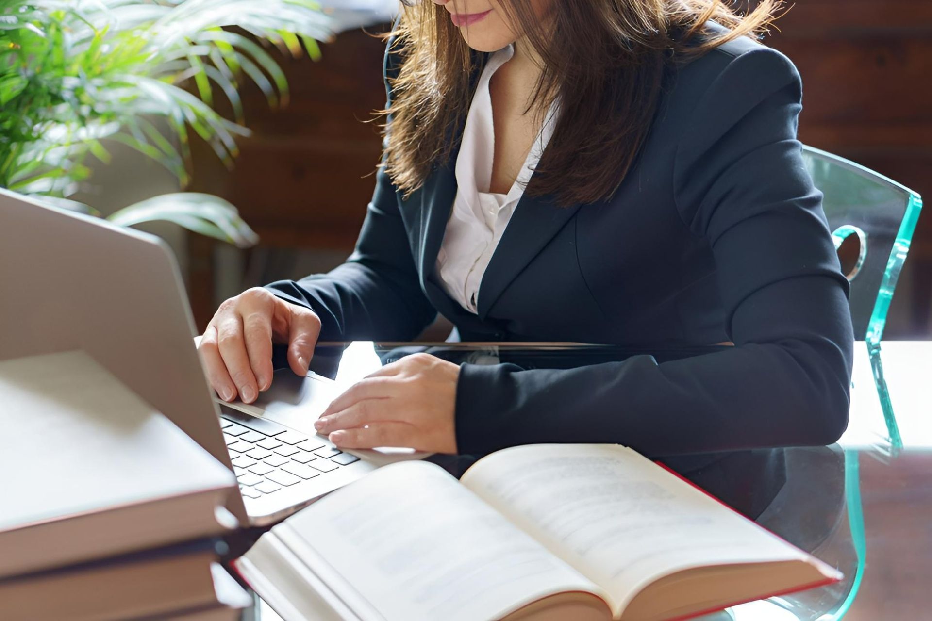 A Woman Is Sitting At A Desk With Laptop — Clarence Valley Legal In Grafton, NSW