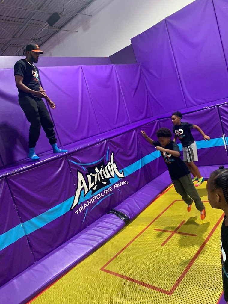 A group of people are jumping on a trampoline.