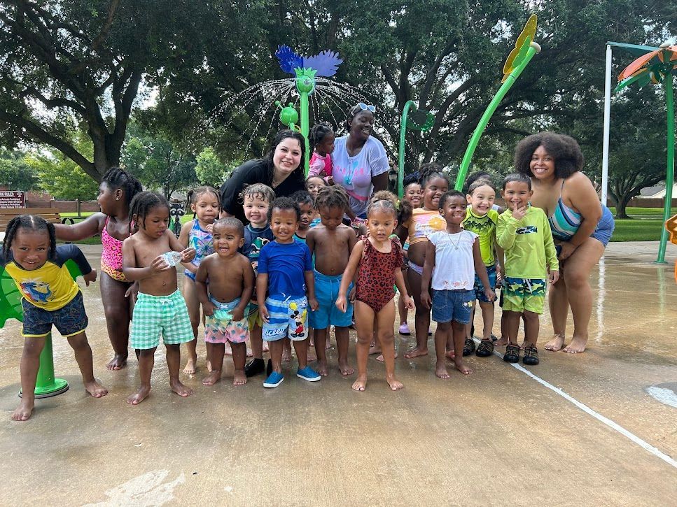 A group of children are posing for a picture at a water park.