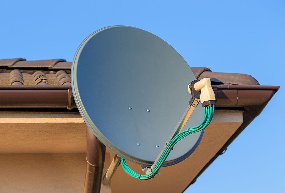 A Satellite Dish Is Attached to The Roof of A House — A1 Antenna Doctor In Port Macquarie, NSW