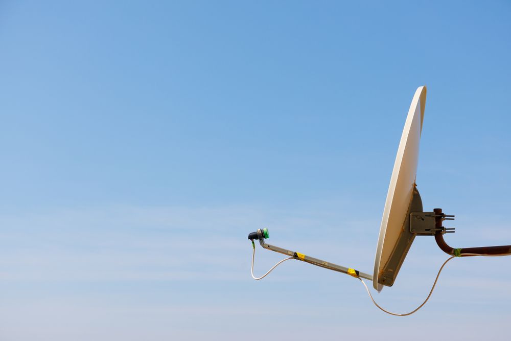A Satellite Dish Is Hanging from A Pole in The Sky — A1 Antenna Doctor In Port Macquarie, NSW
