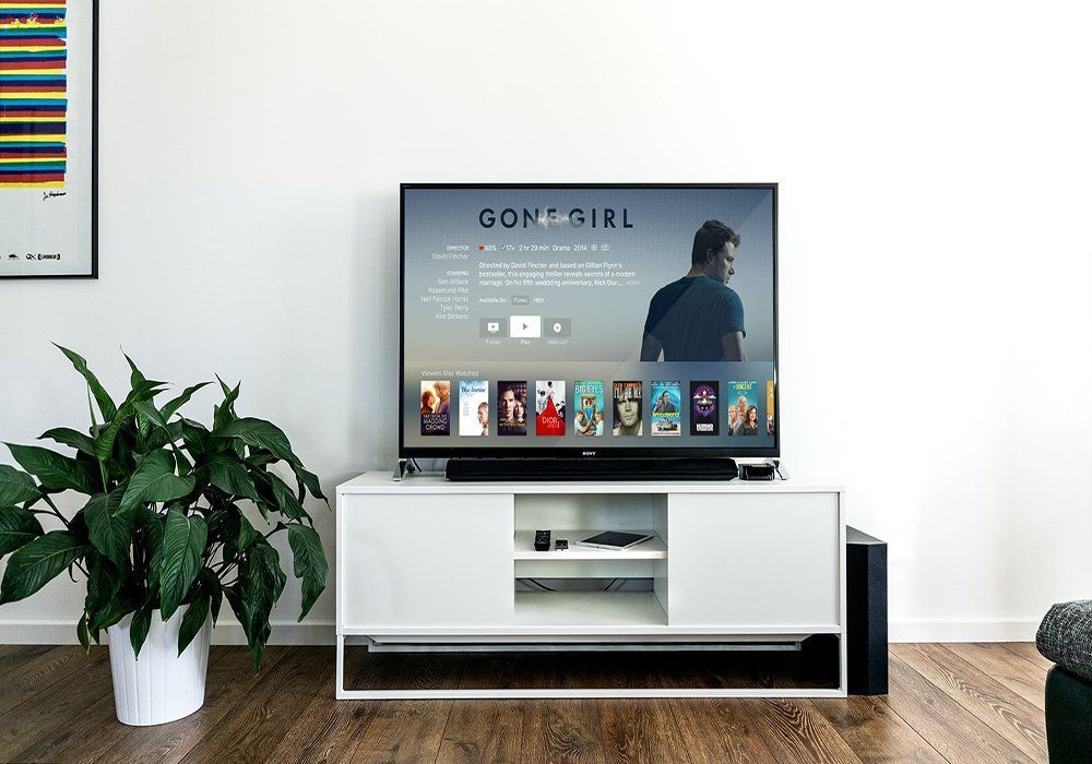 A Flat Screen Tv Is Sitting on Top of A White Entertainment Center — A1 Antenna Doctor In Port Macquarie, NSW