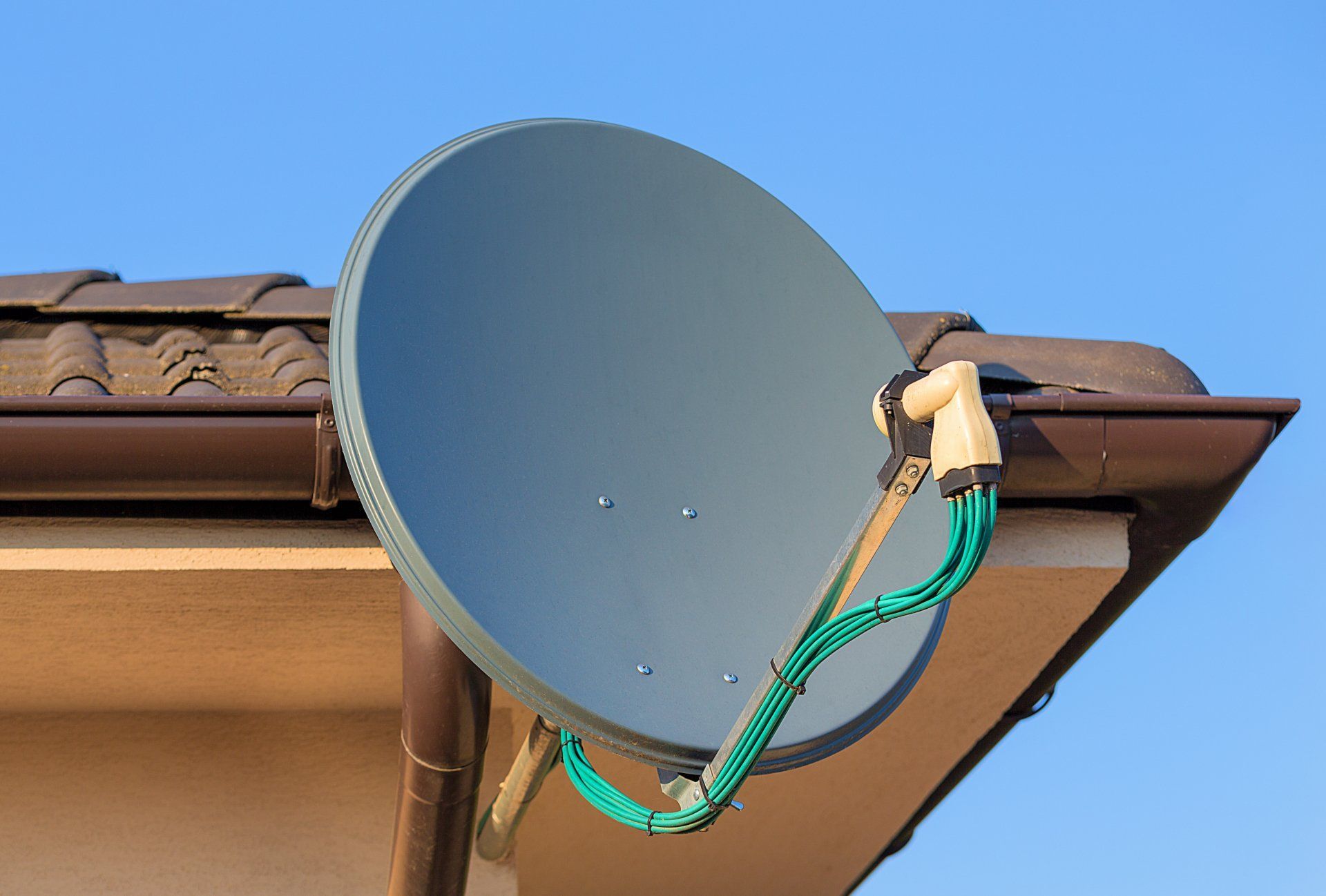 A Satellite Dish Is Attached to The Roof of A House — A1 Antenna Doctor In Port Macquarie, NSW