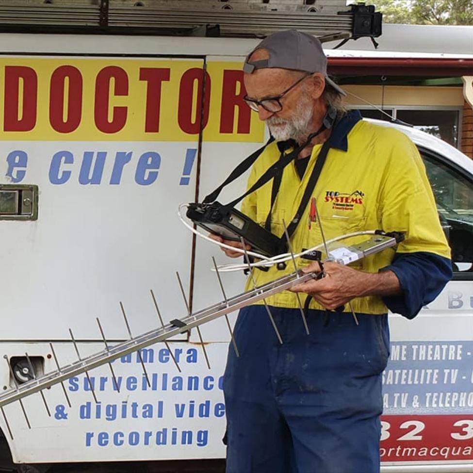 A Man Standing in Front of a Van Holding An Antenna — A1 Antenna Doctor In Port Macquarie, NSW