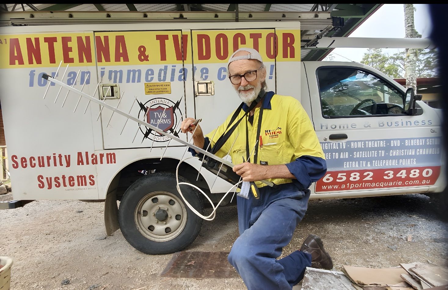 Technician Repairing TV Antenna For Better Reception