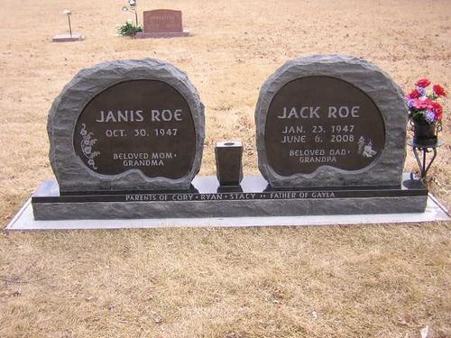 A double headstone for Janis and Jack Roe, featuring two rounded grey granite markers on a shared base in a cemetery.
